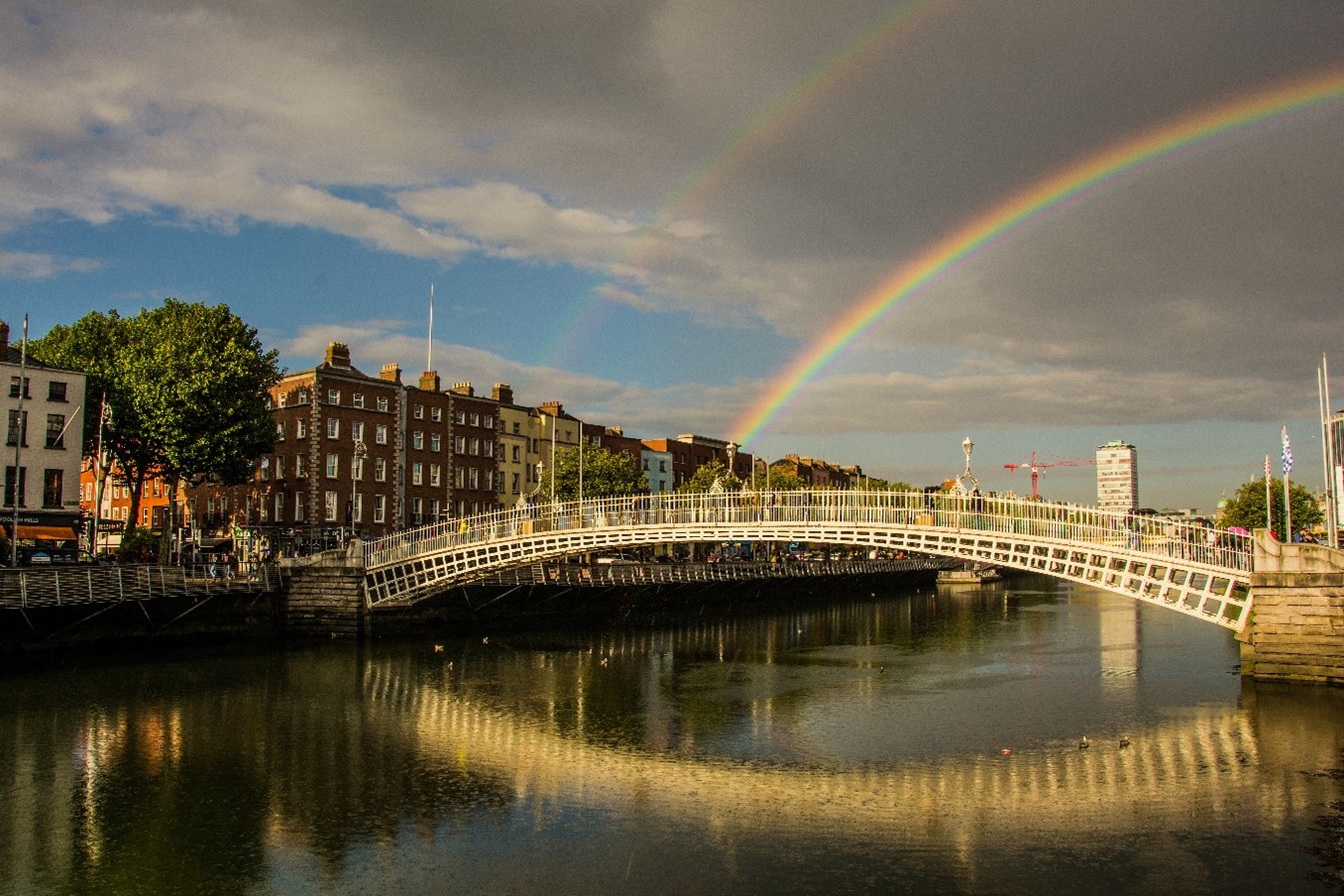 White bridge over water with rainbow